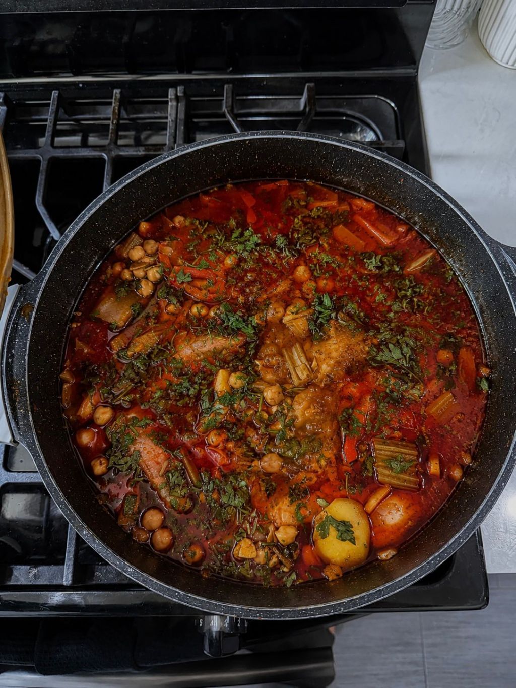 Moroccan fish with vegetables, chickpeas, herbs, and lemon