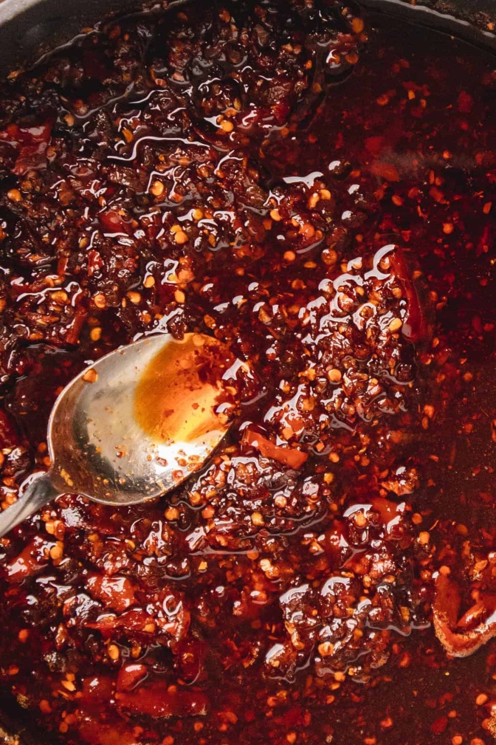 Homemade chili crisp with a spoon in the pan